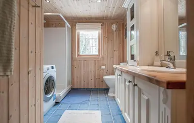 a bathroom with a sink and a washing machine at 5 Bedroom Gorgeous Home In Engerdal in Nymoen
