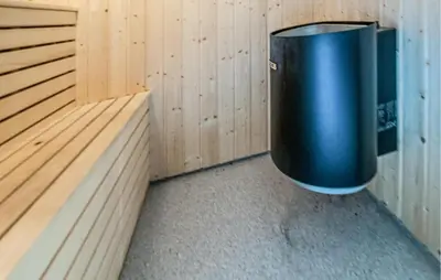 a trash can sitting in the corner of a sauna at 5 Bedroom Gorgeous Home In Engerdal in Nymoen