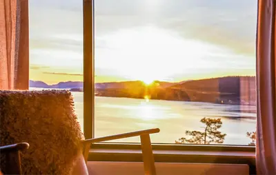 a room with a window with a view of a lake at 3 Bedroom Amazing Home In Åfarnes in Åfarnes
