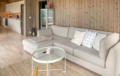 a living room with a couch and a table at 3 Bedroom Amazing Home In Åfarnes in Åfarnes
