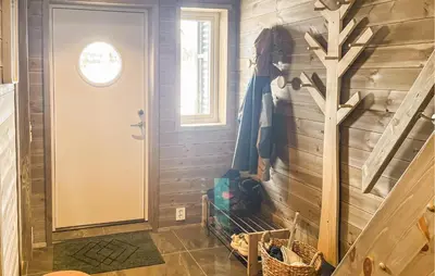 a hallway with a door and a wooden wall at Cozy Home In Ålen With Wifi in Ålen