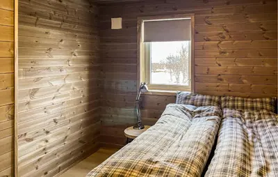 a bedroom with a bed in a wooden room at Cozy Home In Ålen With Wifi in Ålen