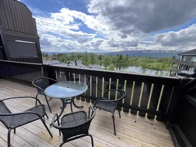 a patio with chairs and a table on a deck at Enjoy Scenic Views From Your Balcony in Beitostøl