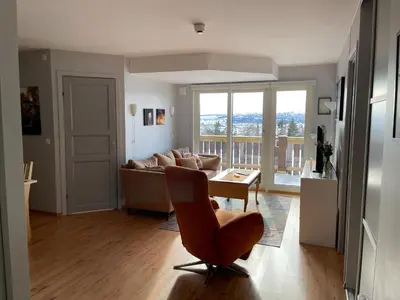 a living room with a couch and a table at Enjoy Scenic Views From Your Balcony in Beitostøl