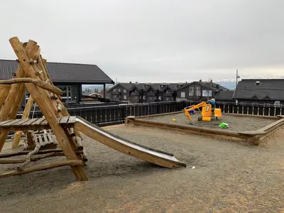 a playground with a wooden slide at Enjoy Scenic Views From Your Balcony in Beitostøl