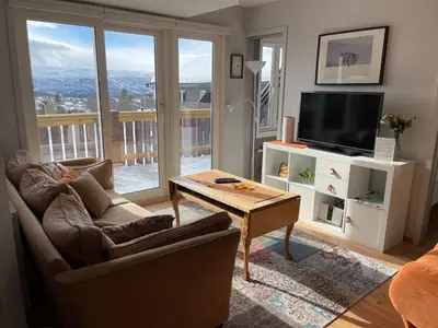 a living room with a couch and a tv and a table at Enjoy Scenic Views From Your Balcony in Beitostøl