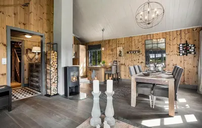 a living room with a table and a fireplace at 4 Bedroom Gorgeous Home In Rauland in Rauland