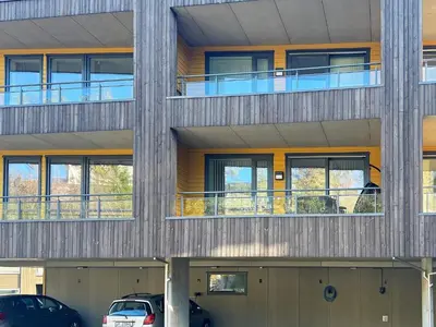 a building with cars parked in front of it at 4 person holiday home in Frekhaug in Hordvik