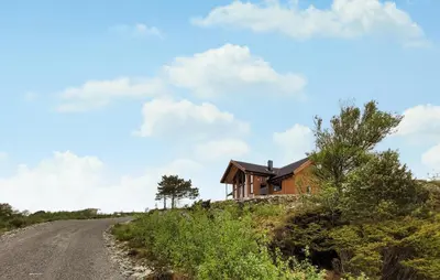 a house on the side of a dirt road at Awesome Home In Sveio in Sveio