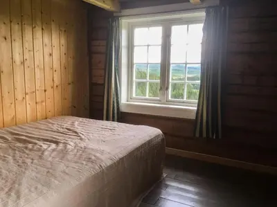 a bedroom with a bed and a window at Newly renovated house on a farm in Berge