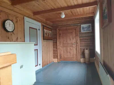 a room with a door and a clock on the wall at Newly renovated house on a farm in Berge