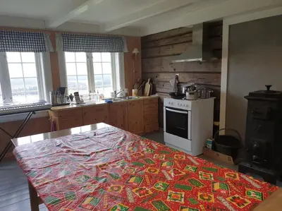 a kitchen with a table with a colorful blanket on it at Newly renovated house on a farm in Berge