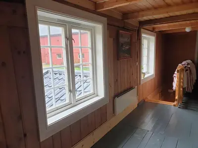 an empty room with a window and a wooden floor at Newly renovated house on a farm in Berge