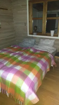 a bed with a colorful blanket in a room at Sleep Over in Eiknes