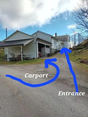 a house with a carport and an entrance at Sleep Over in Eiknes