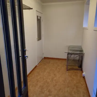 an empty room with a glass table and a door at Lillehammer, Gjøvik pâ 2836 Biri apartments in Biri