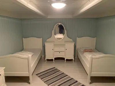 a room with two beds and a mirror at Rikstaddal in Kalvhagen