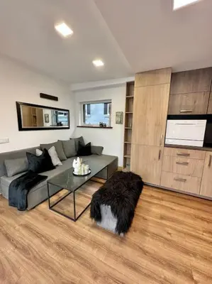 a living room with a couch and a table at Vika Minihouse in Kristiansund