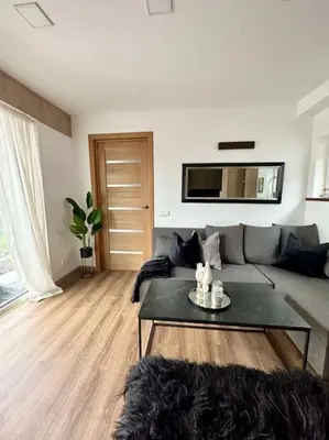 a living room with a couch and a table at Vika Minihouse in Kristiansund