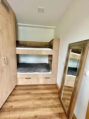 a room with two bunk beds and a mirror at Vika Minihouse in Kristiansund