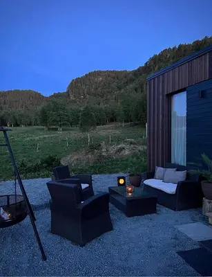 a patio with two chairs and a couch and a table at Vika Minihouse in Kristiansund