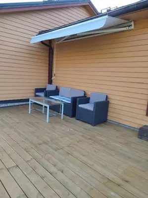 two blue chairs and a table in a garage at Biri nær Gjøvik ,Hamar og Lillehammer apartments in Gjøvik