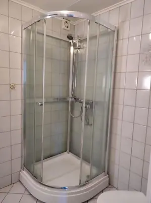 a glass shower in a bathroom with a toilet at Biri nær Gjøvik ,Hamar og Lillehammer apartments in Gjøvik