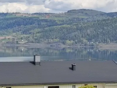 a roof of a building with a view of a lake at Biri nær Gjøvik ,Hamar og Lillehammer apartments in Gjøvik