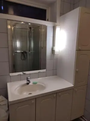 a white bathroom with a sink and a mirror at Biri nær Gjøvik ,Hamar og Lillehammer apartments in Gjøvik