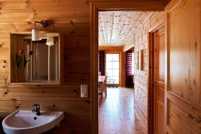 a bathroom with a sink and wooden walls at Fjordhytte-4 nahe Trolltunga, Hardanger, direkt am Maurangerfjord in besonders attraktiver Umgebung in Sundal