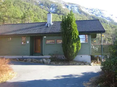 a green house with a tree in front of it at Fjordhytte-41 mit mietbarem 9,9 PS Motorboot am Hardangerfjord in Rosendal