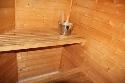 a wooden sauna with a trash can on a shelf at Fjordhytte-41 mit mietbarem 9,9 PS Motorboot am Hardangerfjord in Rosendal
