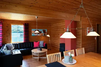 a living room with a couch and a table at Fjordhytte-5 Hardanger-Region, zwischen Odda und Rosendal in Sundal