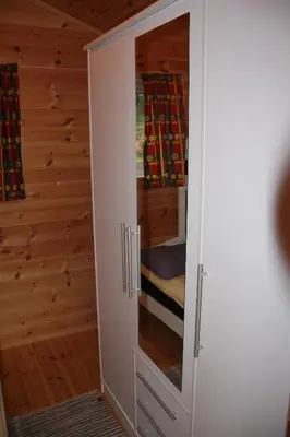 a white cabinet with a mirror in a room at Fjordhytte-39 am Hardangerfjord, Motorboot mietbar in Rosendal