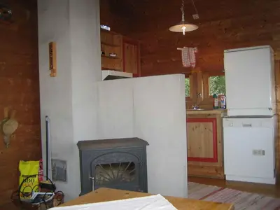 a kitchen with a fireplace and a stove at Fjordhytte-38 bei Rosendal am Hardangerfjord in Rosendal