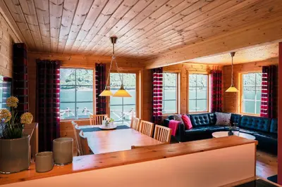 a living room with a table and a dining room at Fjordhytte-6 direkt am Maurangerfjord, einem Seitenarm des Hardangerfjords in Sundal