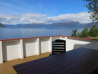 a chair sitting on the deck of a boat at Fjordhytte-17 in Norwegen direkt am Fjord, mit mietbaren 9,9 PS bis 60 PS Motorbooten in Bjordal