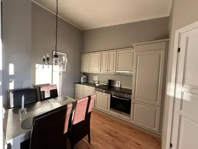 a kitchen with a table and chairs and a dining room at Charming Top Floor Apartment With Balcony in Beitostøl