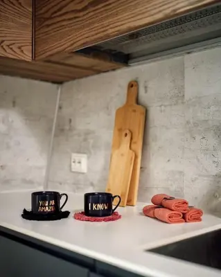 two coffee cups and cookies on a kitchen counter at Fjord-view apartment in Ålesund