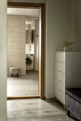 a hallway with a door leading to a laundry room at Fjord-view apartment in Ålesund