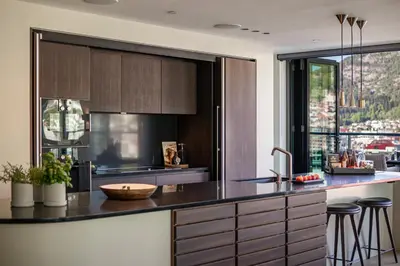 a kitchen with a black counter top and a window at Nordnes Brygge in Bergen