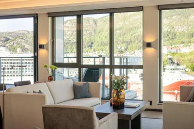 a living room with a couch and a table at Nordnes Brygge in Bergen