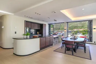 a kitchen and dining room with a table and chairs at Nordnes Brygge in Bergen