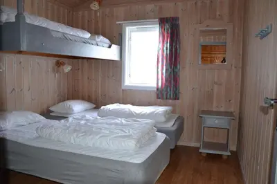 two beds in a room with a window at Lifjellhytte 10 by Norgesbooking - cabin at Golsfjellet in Gol