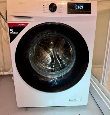 a dryer with a washing machine with its door open at Villa Utsikten Kirketaket in Åndalsnes