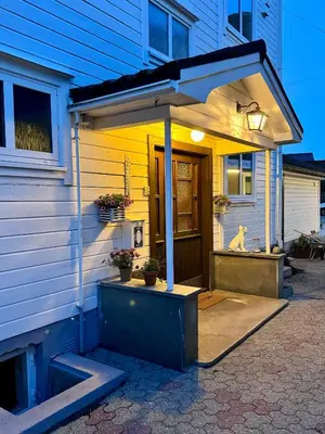 a house with an awning on the front of it at Villa Utsikten Romsdalen in Åndalsnes