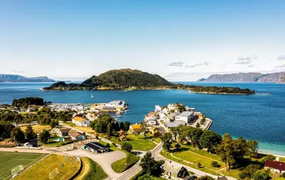 an aerial view of a small town next to the water at Doktorgarden in Selje