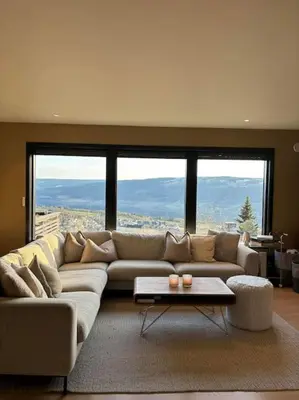 a living room with a large couch and a table at Utsikten in Lillehammer