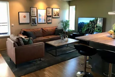 a living room with a couch and a table at Pen leilighet i Trondheim in Trondheim