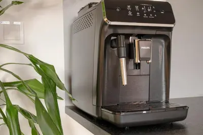 a coffee maker sitting on a counter next to a plant at KS Apartment Modern & cozy flat 20 min from Bergen centre in Espeland